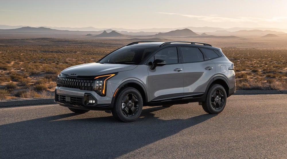 A gray 2026 Kia Sportage SUV parked a desert road